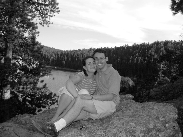 Near Rapid City, SD--Kristin Thomas and Caleb Sancken sit on a rock with a lake in the background.
