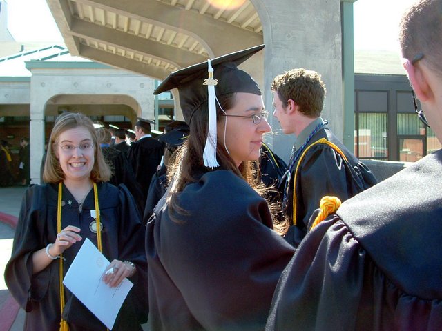 Outside the Union before baccalaureate: Sara Spencer mugs; a less exuberant Tamara Carnahan is profiled in the foreground, and Mike Ross is profiled in the background.