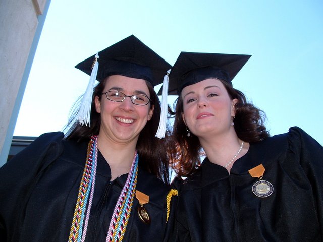 Tamara Carnahan and Kristin Thomas look down upon the camera, outside the Union before baccalaureate.