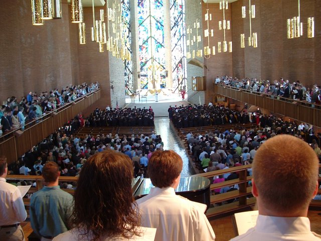 As seen from the choir loft, students take their seats at the front of the Chapel of the Resurrection for baccalaureate.  The heads of Kantorians obscure the bottom of the picture.