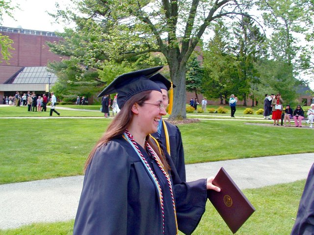 Tamara Carnahan, viewed in profile, is shown laughing east of the Athletics and Recreation Center after commencement.
