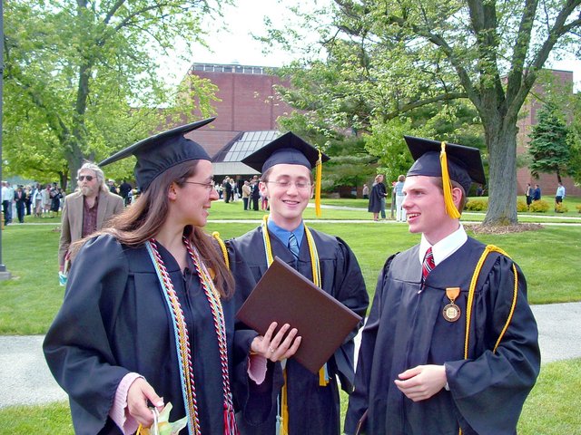 Tamara Carnahan, Dan Alrick, and Matthew Schaefer converse to the east of the Athletics and Recreation Center after commencement.