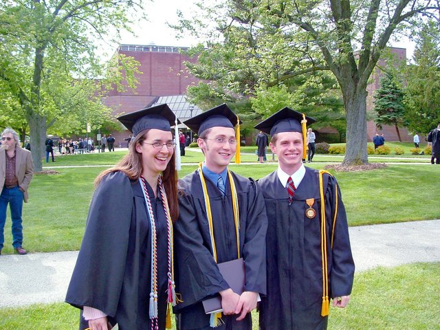 Tamara Carnahan, Daniel Alrick, and Matthew Schaefer pose to the east of the Athletics and Recreation Center after commencement.