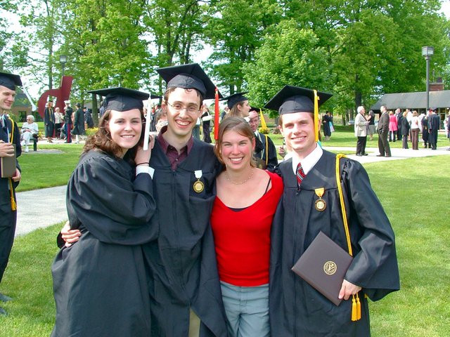 Kristin Thomas, Caleb Sancken, Whitney Tyson, and Matthew Schafer pose near the Valparaiso U. Book Center after commencement.  Steven Wilco, Gina Leon, and Benjamin Hampton are visible in the background.