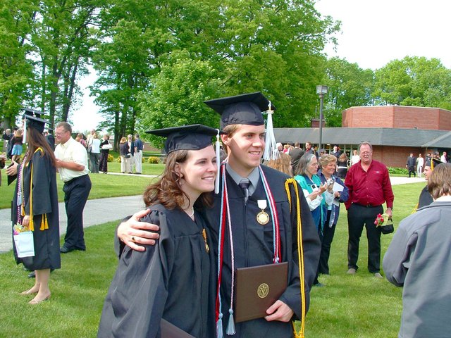 Kristin Thomas and John Unrath, both in profile, pose near the Valparaiso U. Book Center after commencement.
