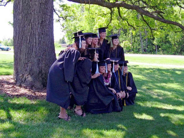 I profile view of Kristin Thomas and her Gamma Phi Beta sisters next to Merlin tree after baccalaureate.  (From Gregory Sancken)