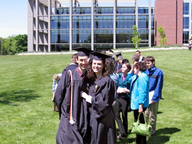 Caleb Sancken and Kristin Thomas pose after baccalaureate in Resurrection Meadow.  Sanckens are in the near background, and in the far background is the east side of the Christopher Center.  (From Gregory Sancken)