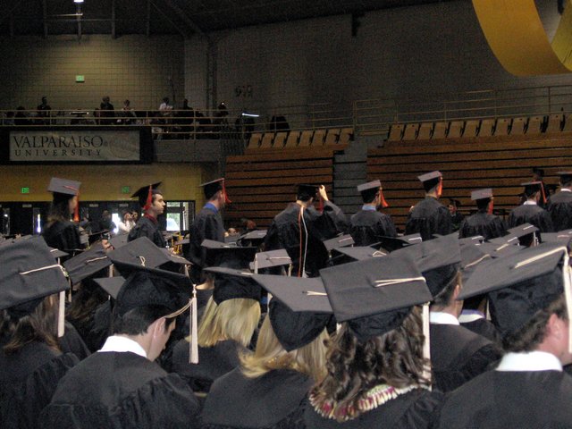 Mechanical Engineering students process to the front to receive their degrees.  Eric Spaeth is visible in profile.  Caleb Sancken adjusts his mortarboard. (From Gregory Sancken)